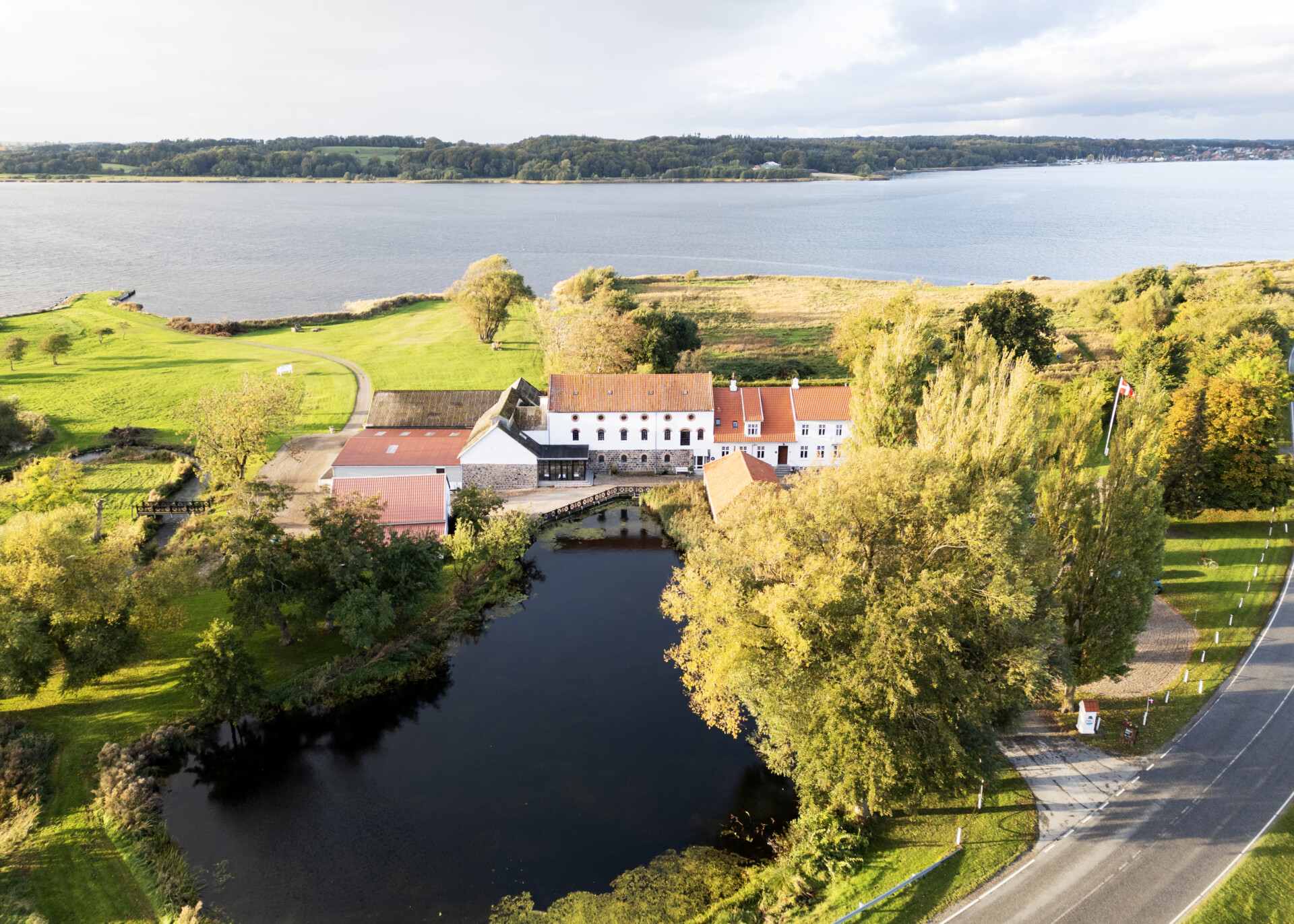 Aamølle og møllesøen set fra luften med Mariager Fjord i baggrunden